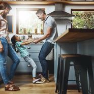 Family hanging out in kitchen together.